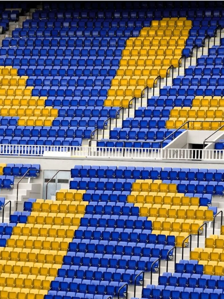 Stadium seats colored in blue and yellow in the shape of Walmart's logo